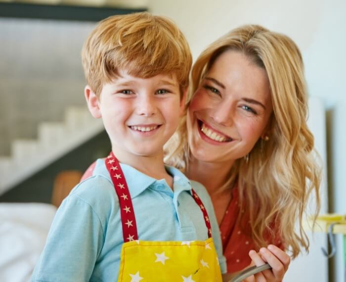 Child and parent smiling together