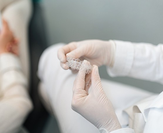 Dentist holding a set of clear aligners