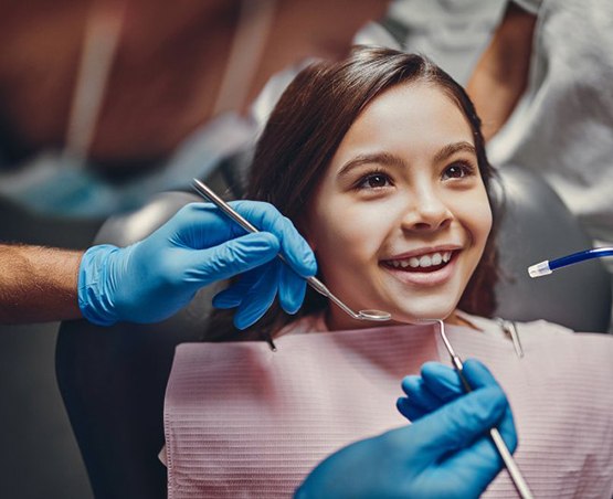 a child smiling during a dental checkup