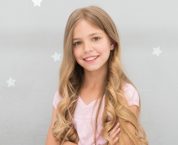 Child smiling after dental checkup and teeth cleaning