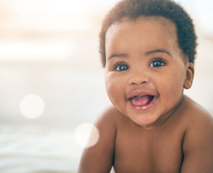 Baby smiling after oral health risk assessment