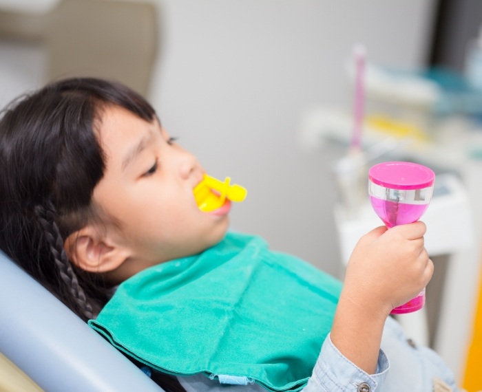 Child receiving fluoride treatment