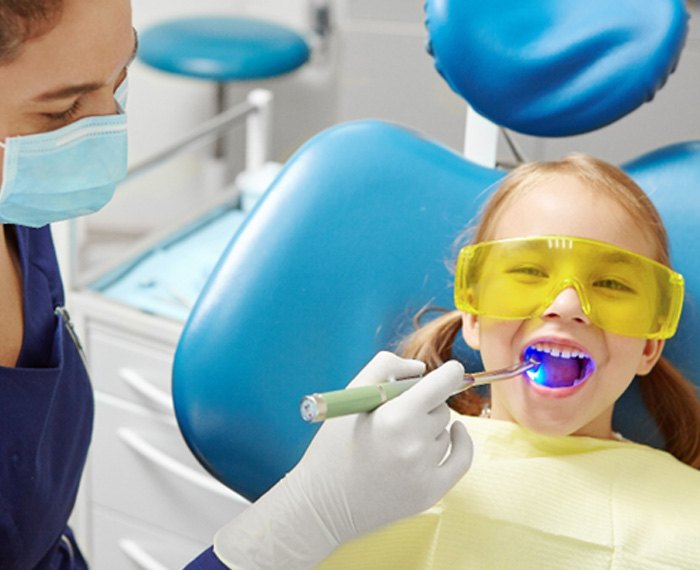 A child receiving pediatric dentistry from her dentist