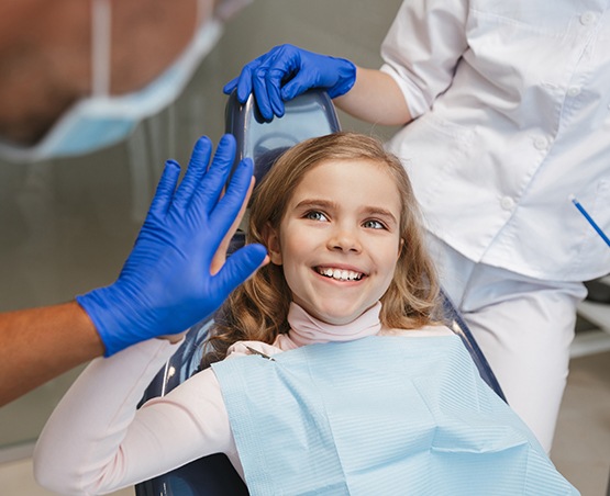 a child high-fiving their orthodontist