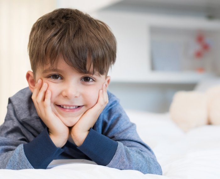 Child smiling after general anesthesia visit