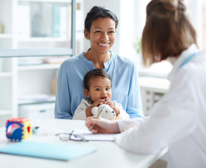 Mother and child talking to dentist in office