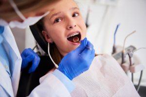 a child smiling while visiting their orthodontist